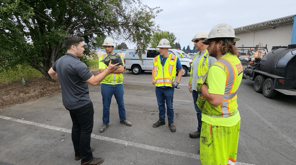 Mike shows a bag of sequestered carbon to asphalt workers