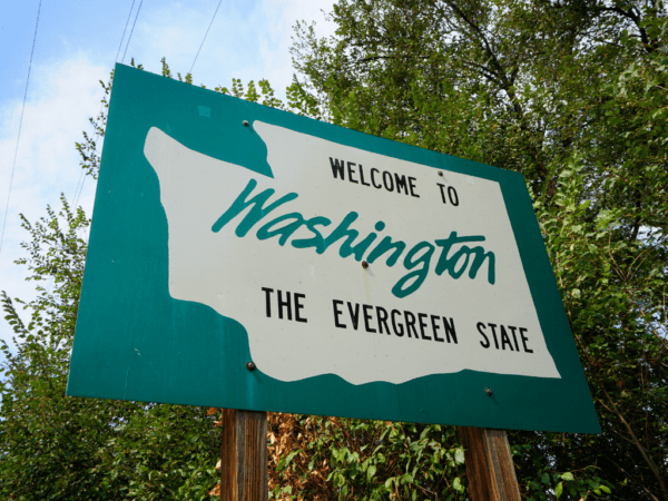 Washington welcome sign with state of washington outline and state's motto