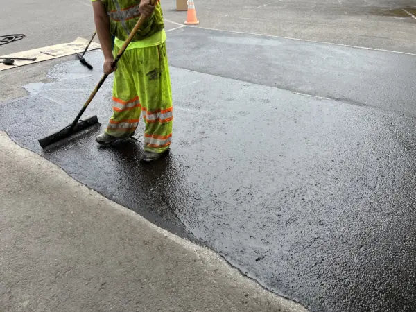applying sealer pigment via broom on pavement for parkinglot. with RNG, this process can contribute to negative emissions. 