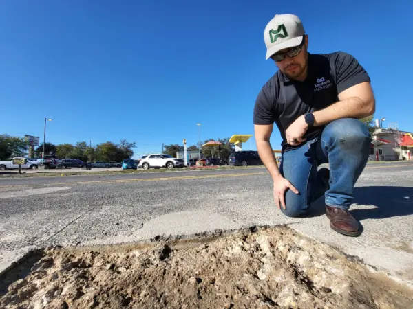 Mike near a pothole that will be filled with decarbonized natural gas carbon