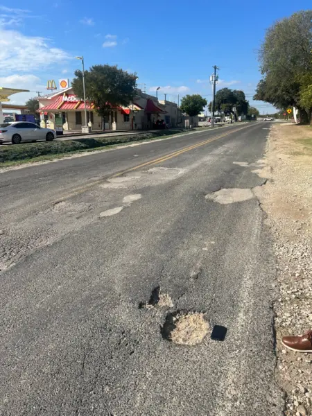 Pothole in San Antonio on the side of a road